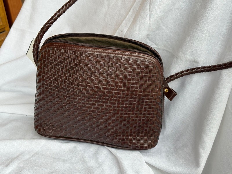 womans handbag all leather crossbody 8 inches in width and 9 3/4 in height.