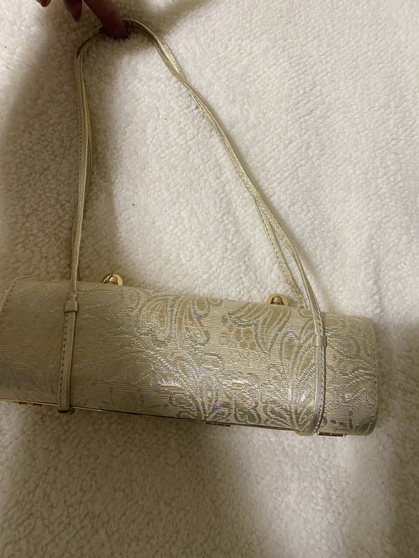 Elegant gold-colored bag, 10 inches long and 5 inches wide, excellent for weddi