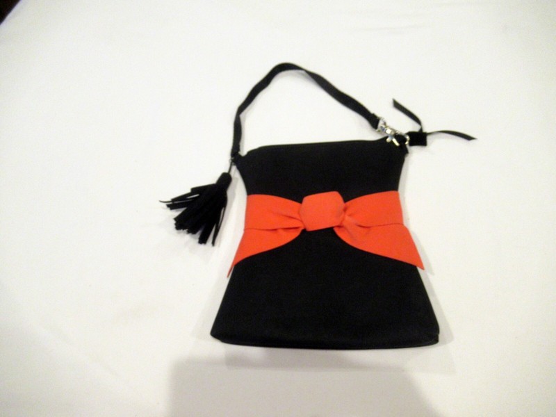 Black purse with red bow and black tassel, evening bag