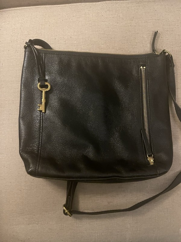 Black Fossil Tara leather crossbody bag featuring a distinctive gold-toned key