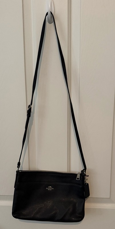 Woman’s Black With Silver Trim. Cross Body- One Side Of Strap Is Tied In knot.