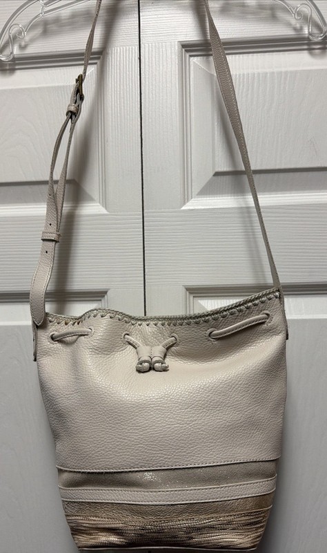 The Sak Ivory Leather Bucket style , 3 small strips of color leather at Bottom